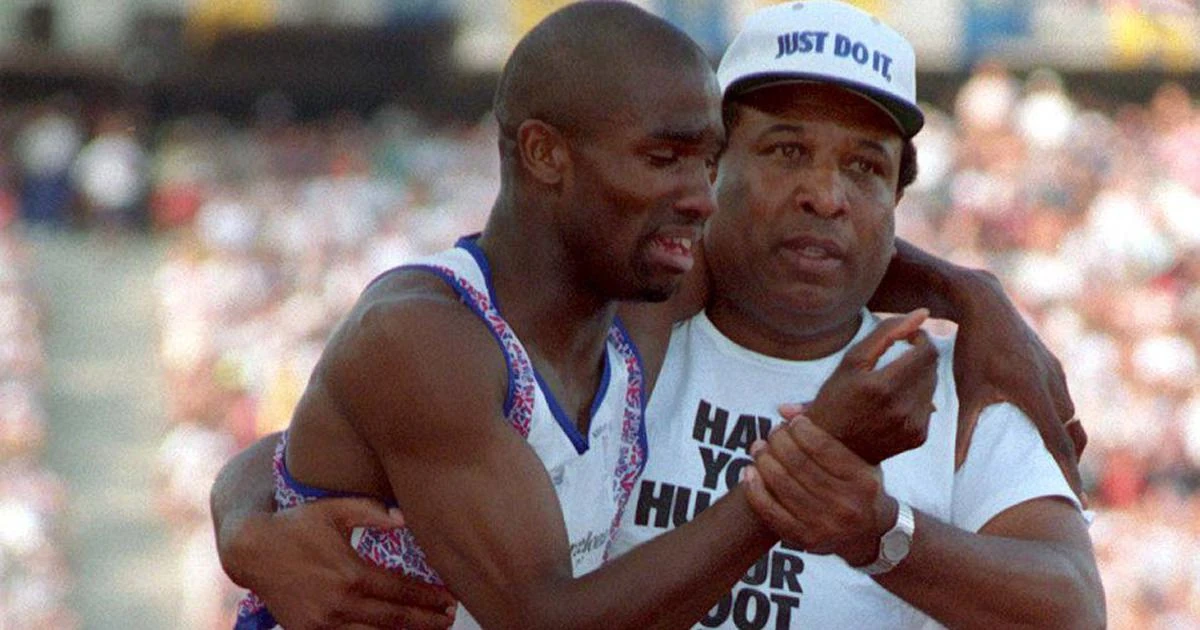 Derek Redmond supported by his father Jim as they continue toward the finish