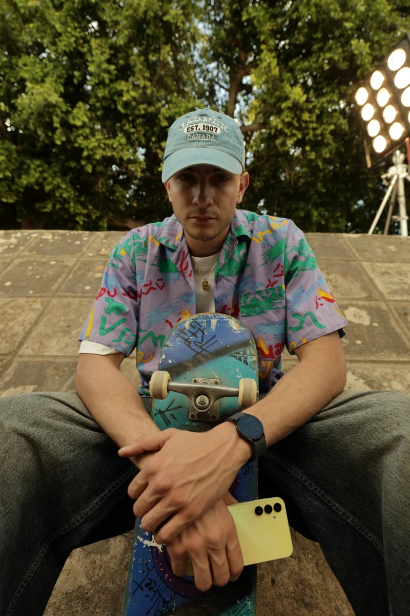 Fares Abdeddayem outdoors with a skateboard and Galaxy A15