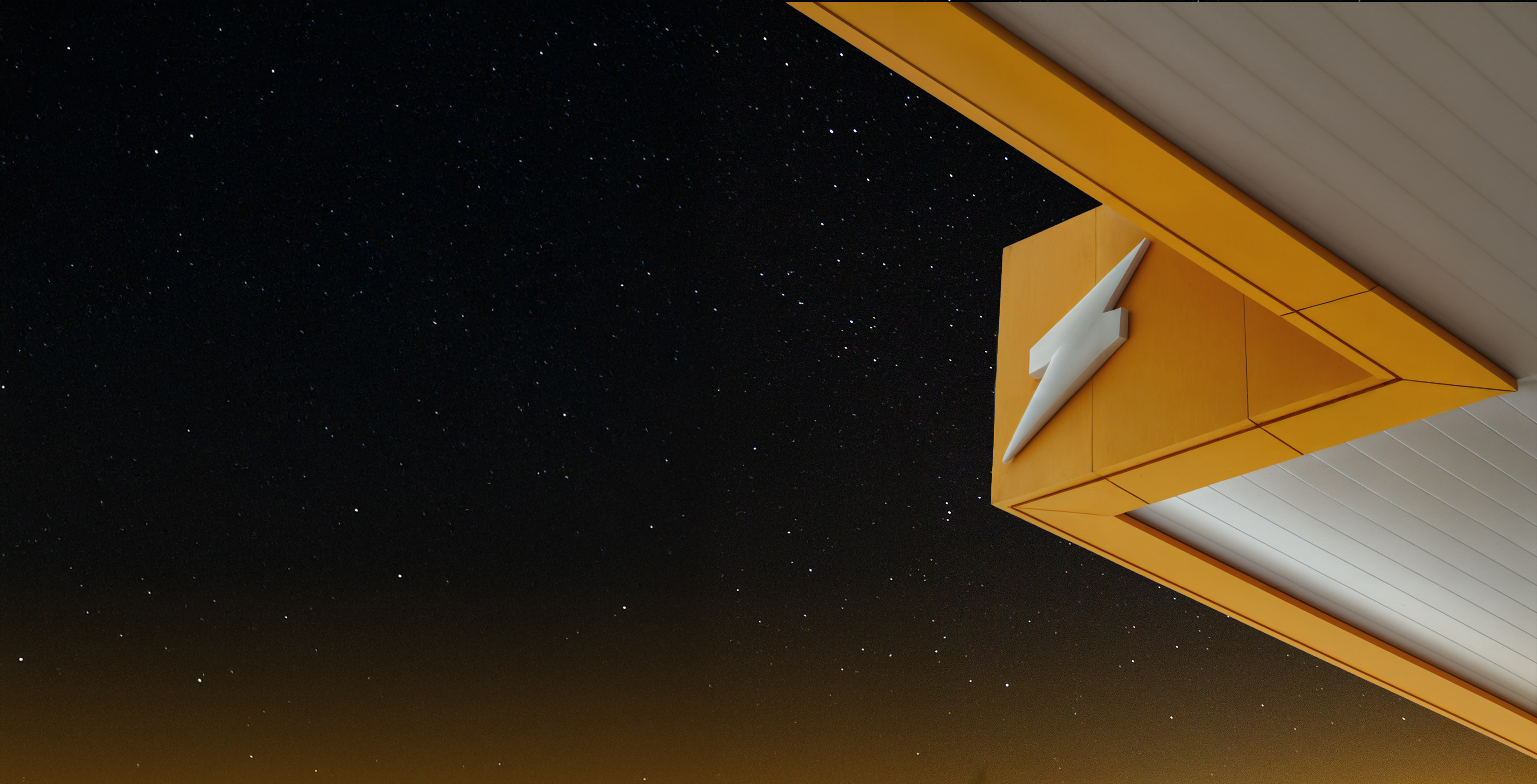 Winamp lightning bolt on a modern building at night
